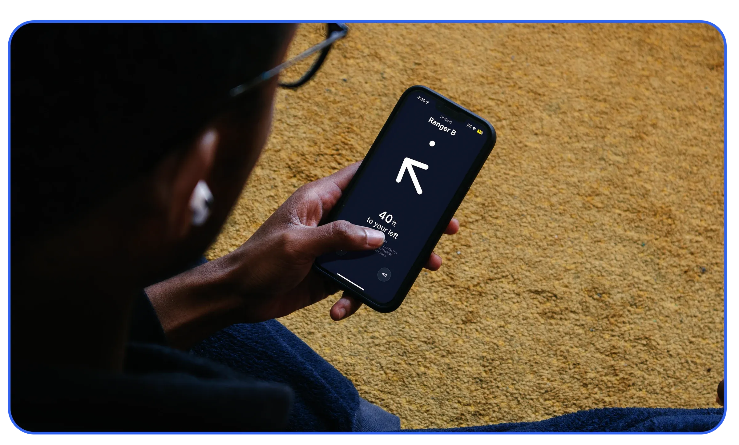Someone holding a phone showing the Fling compass pointing to Ranger B, 40 ft to the left